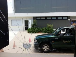 Picture of smashed glass with ute in the background