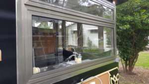 Large framed window smashed in coffee trailer